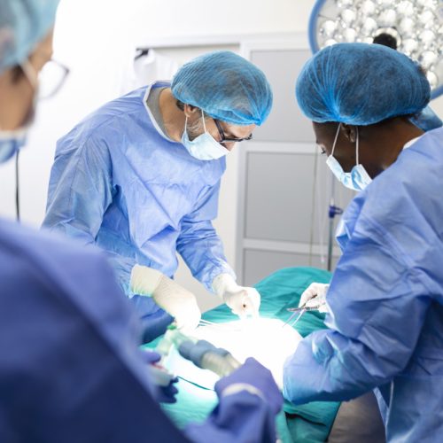 Surgeon team in uniform performs an operation on a patient at a cardiac surgery clinic. Modern medicine, a professional team of surgeons, health.